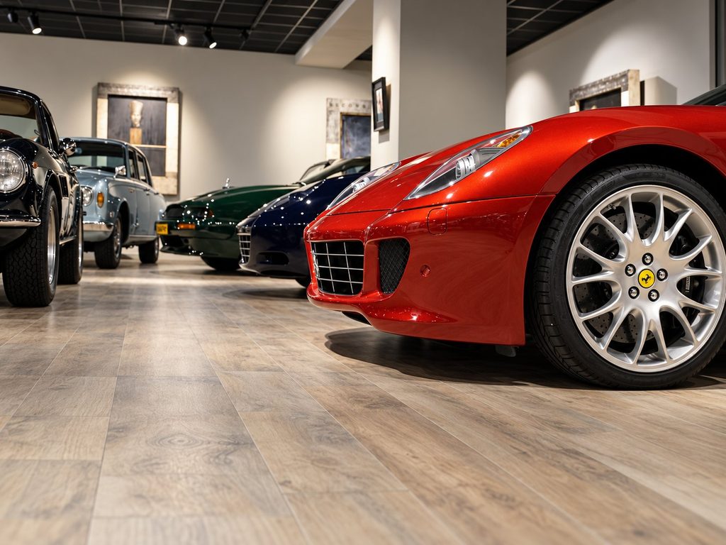 Red Ferrari 599 among classics in the showroom